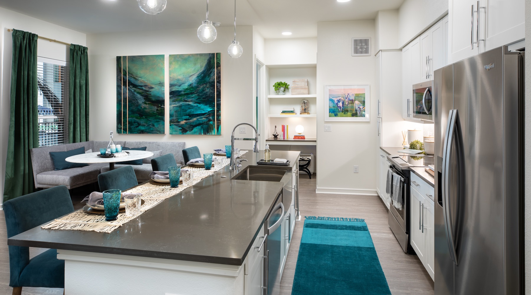 Kitchen Spacious and well lit kitchen with wood floors and stainless steel appliances